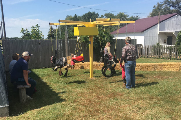 Group of people playing on the tire swings.